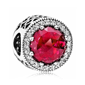 Polished silver charm featuring a large red crystal and micro-pave white stones