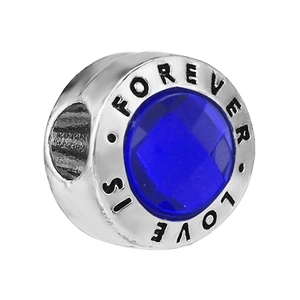 Polished silver charm with blue faceted gemstone and Love Is Forever engraving
