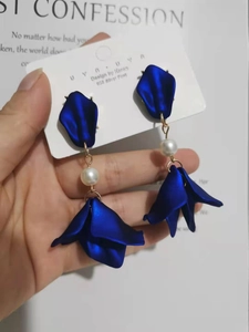 Close-up of layered navy blue petal earrings with white pearls and 925 silver needles
