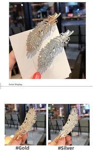Detail of feather-shaped hair clips with rhinestones and bow in gold and silver
