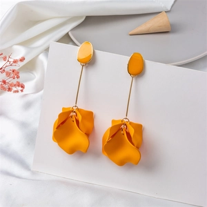 Macro view of long petal earrings featuring layered yellow waves and gold slim rods