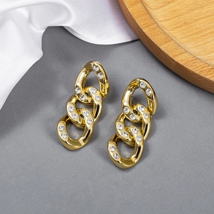 Detailed close-up of golden CCB chain link earrings with inlaid sparkling rhinestones