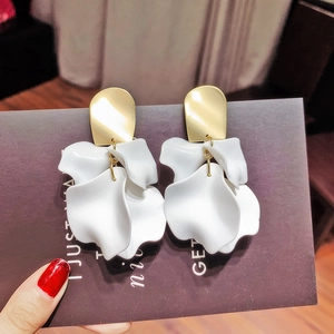 Macro detail of elegant 925 silver needle earrings with white matte floral petals