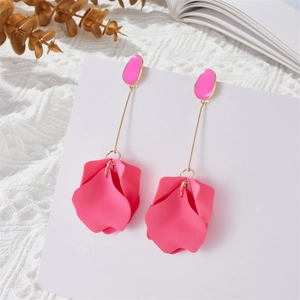 Detail of rose pink petal drop earrings with gold rod and matte texture on white lace