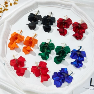 Long multi-layered petal leaf tassel earrings in five vibrant colors on a white vintage tray