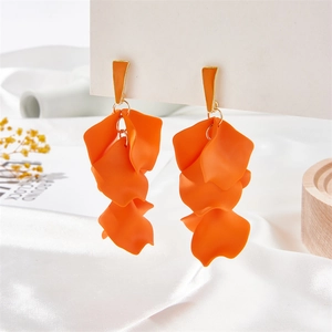 Bohemian orange layered petal tassel earrings with golden studs on white satin backdrop