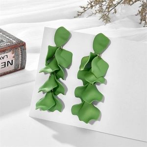 Detailed shot of matte green layered petal tassel earrings on a display card