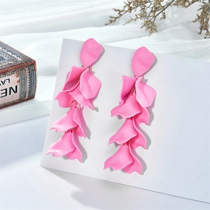 Close-up of pink petal tassel earrings with matte finish on a vintage display