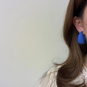 Royal blue matte C-shaped hoop earrings for women shown as a side view on a model
