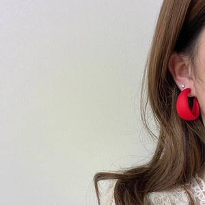 Vibrant red matte C-shaped earrings with stud for women, shown on a model side view