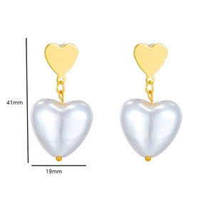 Detail of baroque heart pearl earrings with size measurements of 41mm by 19mm in gold