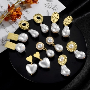 Vintage baroque pearl earring set with textured gold plating on elegant black silk display
