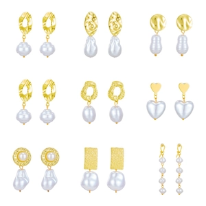 Vintage baroque pearl earrings set in gold metal finish with irregular shapes