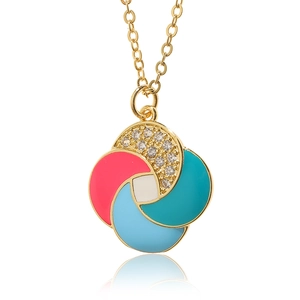 Macro view of colorful enamel windmill pendant with sparkling zircons on gold chain