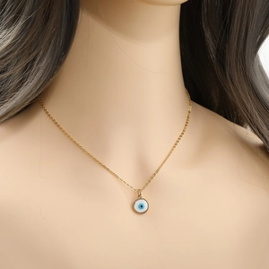 Golden delicate chain necklace with a classic round blue evil eye amulet pendant