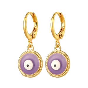 Macro detail of gold-plated evil eye earrings with lavender enamel and twisted texture