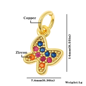 Macro detail of a 14mm gold butterfly pendant made of copper with colorful zircon stones