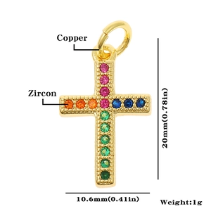 Macro detail of gold-plated copper cross pendant with colorful zircon stones
