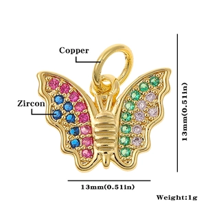 Detailed macro view of a 13mm copper butterfly pendant with colorful zircon stones