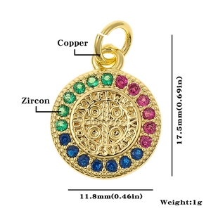 Detailed macro view of gold copper pendant with colorful zircon stones and relief carving