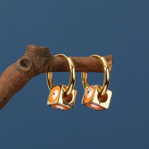 Golden square evil eye drop earrings on branch background with orange enamel detail