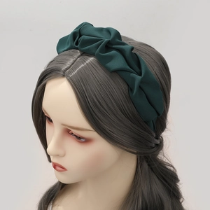 Cerchietto largo a pieghe verde scuro alla moda su modella con elegante stile vintage