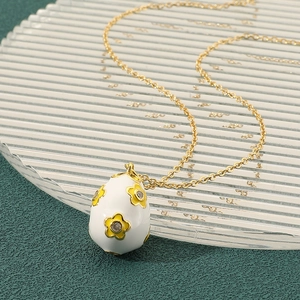 Exquisite gold floral drop pendant necklace with white enamel and sparkling zircon detail