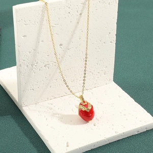 Elegante Goldkette mit vintage rotem ovalem Anhänger und Kristallen auf Marmorständer