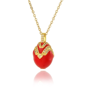 Nahaufnahme roter Emaille-Ei-Anhänger mit goldenem V-Zirkonia-Inlay an feiner Kette