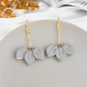 Macro view of gold petal earrings with matte grey leaf pendants and 925 silver studs