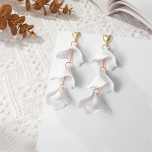 Macro detail of elegant three-tier white matte flower petals with gold heart studs