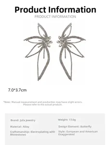 Detailed view of oversized silver butterfly earrings with full rhinestone inlay measurements