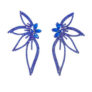 Detailed view of silver butterfly earrings with sparkling blue rhinestones and gems