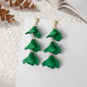 Detail of green petal long earrings with heart studs on a white display card
