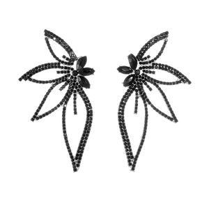 Macro detail of silver-tone leaf earrings featuring sparkling black rhinestones