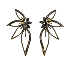 Detailed view of leaf earrings with black rhinestones and golden metal edging design