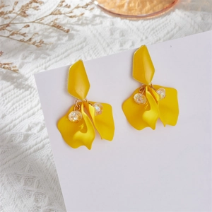 Detailed close-up of yellow petal drop earrings with vibrant beads on a white card