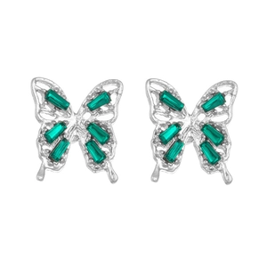 Detailed close-up of silver butterfly studs with rectangular green gemstone inlays
