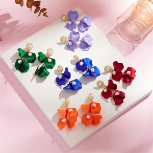 Detail view of colorful layered petal tassel earrings with elegant pearl embellishments