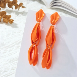 Chic long orange petal tassel earrings with gold link accents on white textured fabric