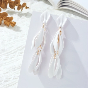 Detail of elegant long tassel earrings featuring matte white 3D flower petal charms