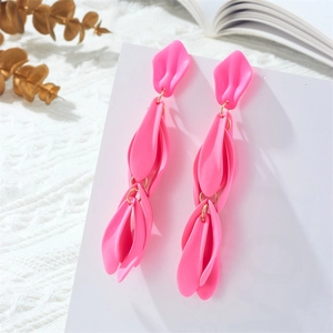 Detail of hot pink multi-layered petal dangle earrings with golden metal links