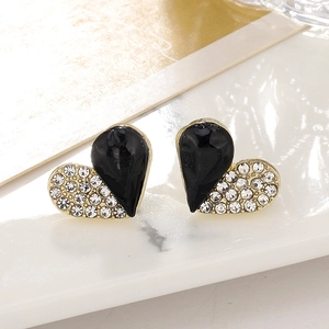 Macro shot of heart earrings with black enamel and micro-paved crystals in gold plating