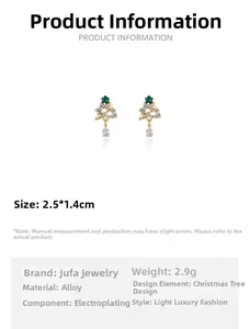 Detail of Christmas tree earrings with green crystals and a teardrop zircon drop