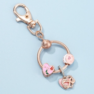 Rose gold Mom keychain with pink enamel heart and infinity love pendant on blue background