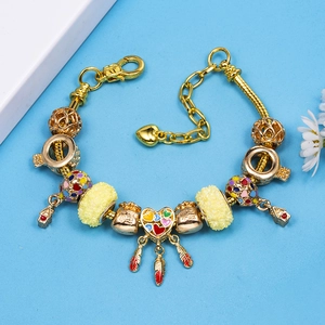 Golden snake chain bracelet with colorful enamel dreamcatcher and fortune bag charms