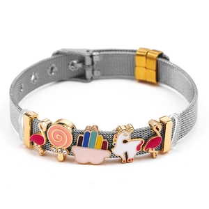 Close-up of rainbow charms and enamel pendants on a mesh bracelet with gold clasp