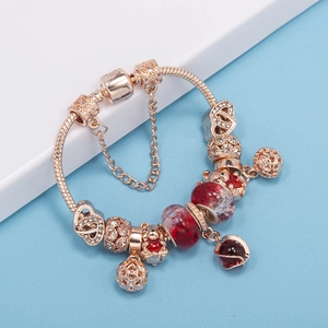 Rose gold snake chain bracelet with red glass beads and heart charm pendants