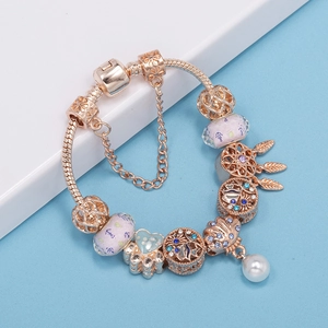 Rose gold snake chain bracelet with heart charms and pink beads on a clean stage