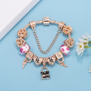 Rose gold DIY charm bracelet with crystal heart, key, love lock, and pink glass beads